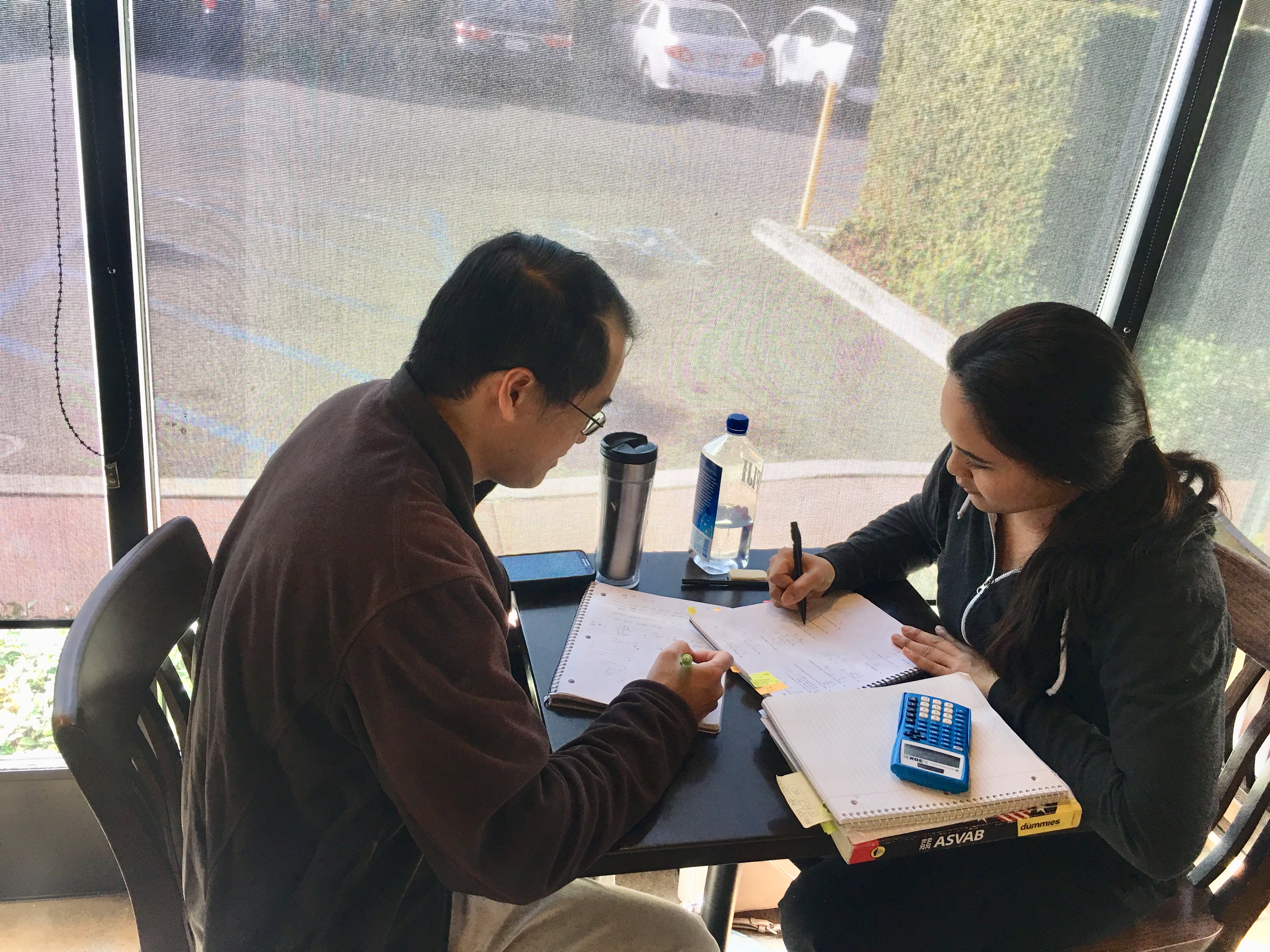 Henry Nguyen tutoring a student for the ASVAB. She later successfully joined the US Air Force.